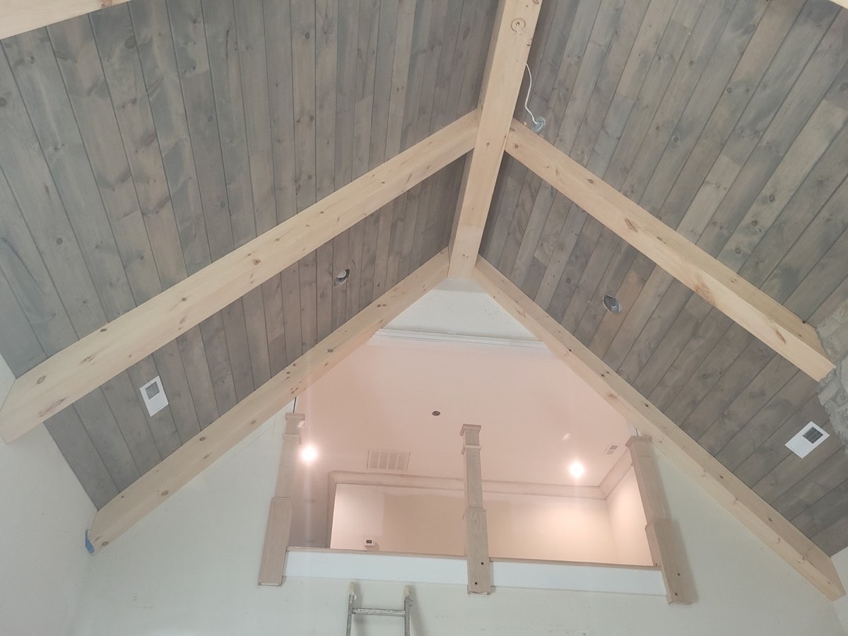 Shiplap ceiling with exposed beam accents